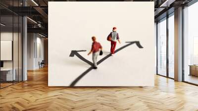 A miniature woman and a miniature man standing on two ways. Wall mural