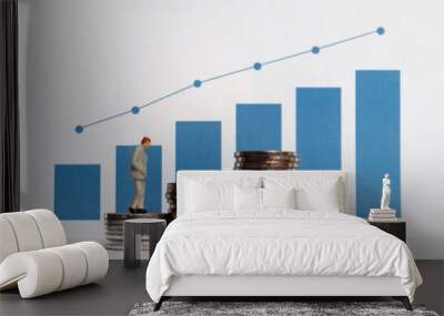 Blue bar graph with flow linear graph. The stack of coins and miniature older people. Wall mural