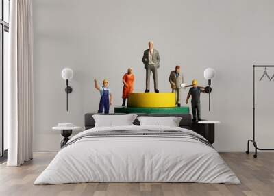 Concept of social stratification. Round wooden blocks and miniature people. Wall mural