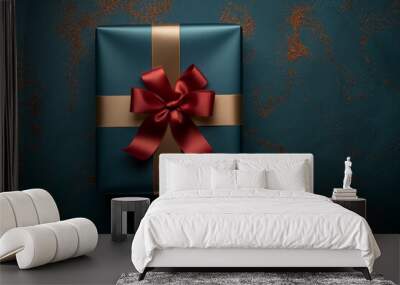 Beautiful wrapped present with a red ribbon and bow in a blue box for a surprise gift event Wall mural