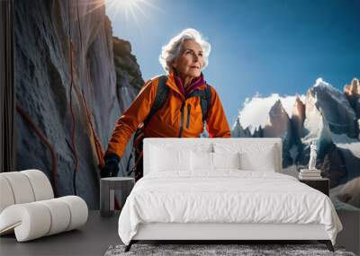 Old woman hiking up a snowy mountain with a backpack on her back Wall mural