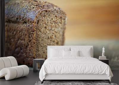 a loaf of black bread on a wooden background, the concept of rising bread prices Wall mural