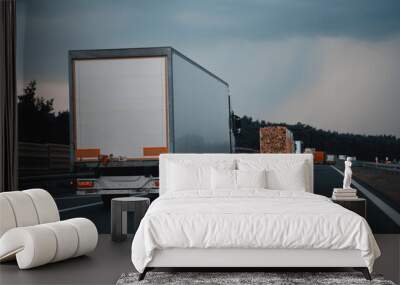 Modern Semi-Trailer Trucks On The Highway Driving In The Right Lane. Commercial Vehicle For Shipping And Post Delivery. Shipping Of The Goods On Land Door-To-Door Wall mural