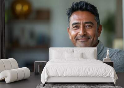 Middle-aged South Asian man working on laptop in home office with copy space Wall mural