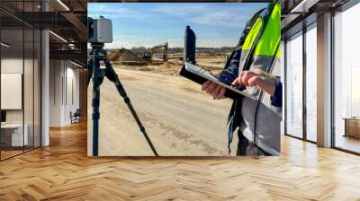 engineer surveyor at the construction site Wall mural