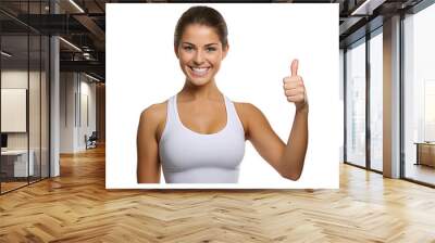 Smiling woman giving a thumbs up gesture in a casual sporty pose, showing happiness and success Wall mural