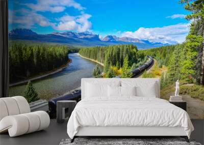 Long freight train moving along Bow river in Canadian Rockies ,Banff National Park, Canadian Rockies,Canada. Wall mural