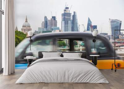 London cityscape with a black cab in motion at the foreground Wall mural