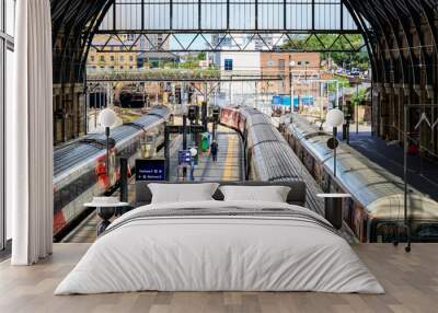 Trains stop at the platforms in Kings Cross train station Wall mural