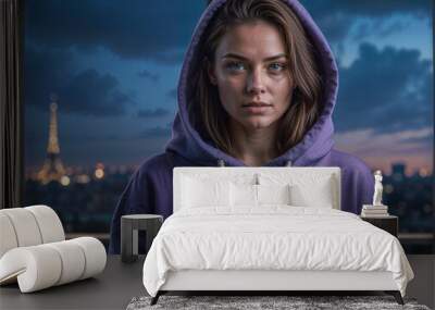 Portrait of a young woman in a blank purple hoodie looking at the camera. Mockup design concept Wall mural