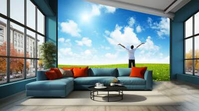 field of grass and happy young man Wall mural