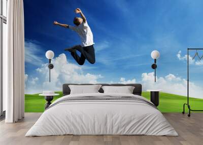 jumping happy young man Wall mural