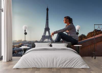 woman and Eiffel tower in sunrise time, Paris, France Wall mural