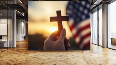 Hand holding cross with American flag in background, religious patriotism, faith and freedom, sunset sky, symbol of belief, Christianity and nationalism, spiritual freedom, USA Wall mural