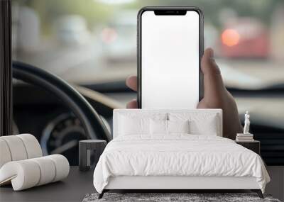 Person holding smartphone with blank White screen inside car, phone mockup, technology and navigation concept, modern mobile phone, driving and GPS, close-up view Wall mural