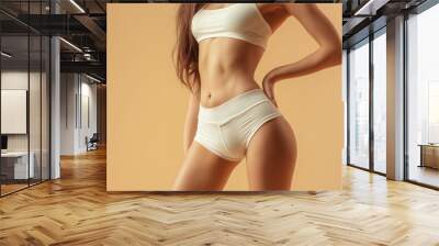 Woman in light colored underwear, toned stomach, studio shot, health and fitness, beauty model, flat abs, athletic body, fitness photography, active lifestyle Wall mural