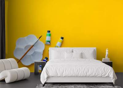 top view of brushes, color tubes and palette on yellow background, copy space, flat lay, paintings art concept Wall mural