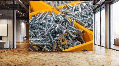 Woodscrews. Pile of wood screws sorted in yellow box storage container. Wall mural