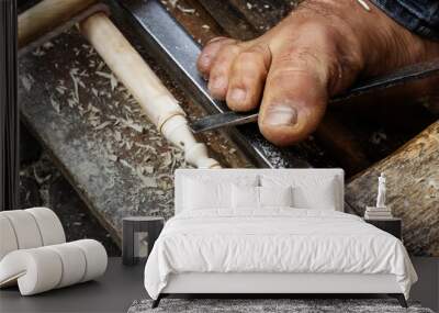 foot holding a chisel on a hand lathe turning wood in the souk market in the medina in Marrakesh, Morocco Wall mural