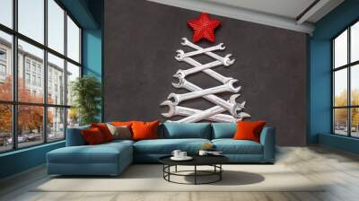 Christmas tree made of tools. Wrenches spanners on black background. Industrial greeting card and happy new year creative concept. Wall mural