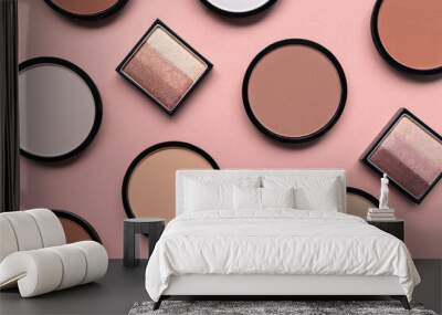 Cosmetic products for makeup on pastel pink background. Beige eyeshadow, blush and face compact powder for different skin colors concept. Trendy beauty pattern. Top view. Flat lay. Closeup. Tone cream Wall mural