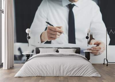 Close up of businessman signing contract or documents at his office, business concept Wall mural