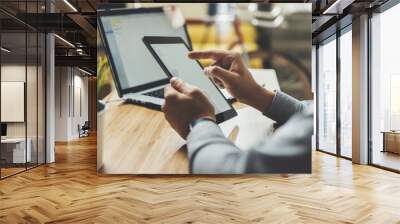 close-up of male hands using modern digital tablet and laptop while working from home, young profess Wall mural