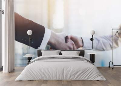 Closeup image of business partners making handshake outdoors, modern office or skyscrapers on the background, flare light Wall mural