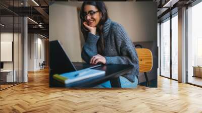 Happy smiling young woman using laptop computer device while working remotely at home office, Cheerful businesswoman in casual clothes having video meeting via laptop, Video Chat Communication Concept Wall mural