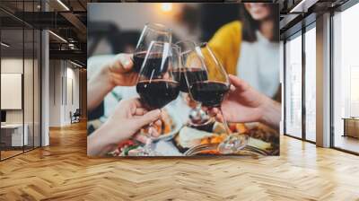 Vertical image of happy friends cheering with wine glasses at home, family celebrate anniversary enjoying healthy homemade food, Dinner Enjoyment Holidays Friendship Concept Wall mural