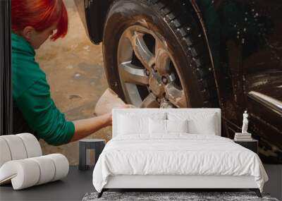 An employee of the car wash thoroughly washes conducts detaling and applies protective equipment to the body of an expensive car. Wall mural