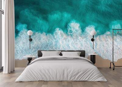 Aerial view of ocean waves washing over sandy beach creating picturesque coastline. Perfect for travel, vacation and coastal themes. Tropical beach image. Wall mural