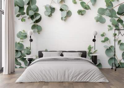 Eucalyptus leaves on white background. Frame made of eucalyptus branches. Flat lay, top view, copy space Wall mural