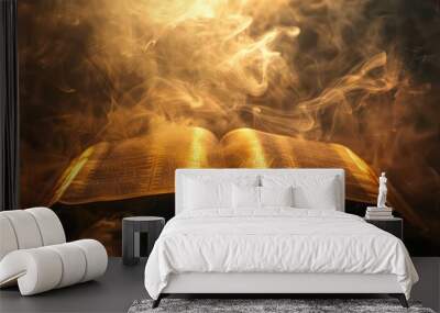 Open bible on a dark background with rays of light and smoke Wall mural