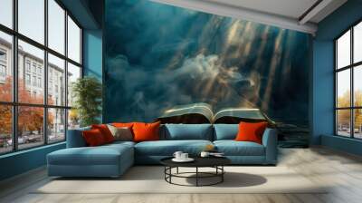 Open bible on a dark background with rays of light and smoke Wall mural