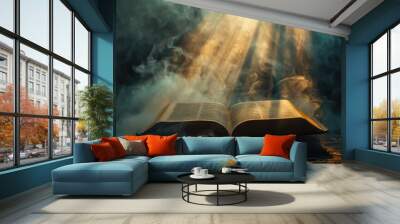 Open bible on a dark background with rays of light and smoke Wall mural