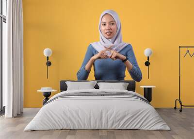 asian indonesian muslim woman showing X sign no hand gesture on isolated yellow background Wall mural