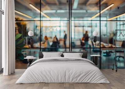 Blurred office scene behind a glass wall, with people working at desks and modern interior design elements Wall mural