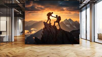 Hiker helping friend reach the mountain top Wall mural