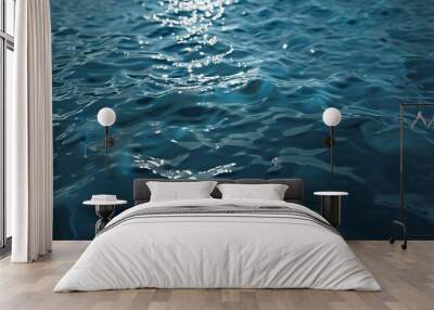 Water surface background. Blue and wavy water texture with sunlight reflections. Wall mural