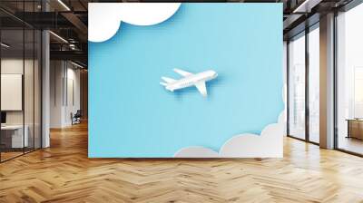 Airplane flying through cloud on blue sky. Airplane aerial view. paper cut and craft style. vector, illustration. Wall mural