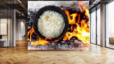 A pan of boiled rice on fire. Cook kitchen fry concept. A pan of food with white and rice on a . A pan with boiled rice and white lifestyle food on the. Wall mural