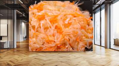 pickled pickling. Grated pickled carrots with cabbage lie on a black plate close-up, healthy concept Wall mural