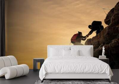 Asia couple hiking help each other silhouette in mountains with sunlight. Wall mural