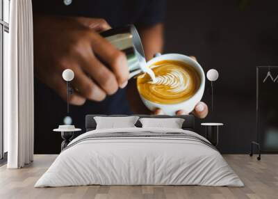 Barista making a cup of coffee latte art in coffee shop.. Wall mural