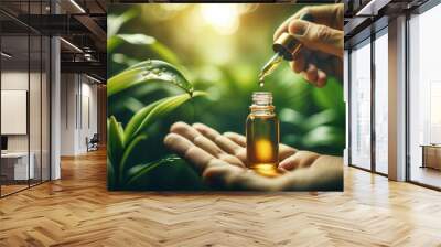 Cannabis oil droplet in hand with marijuana buds - CBD hemp oil, alternative medicine Wall mural