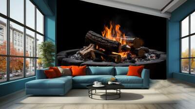 A fire pit with logs and flames on a black background. Fire flames on black background. For art work design, banner or backdrop. Flames against a black background. Fire concept. dangerous concept. Art Wall mural