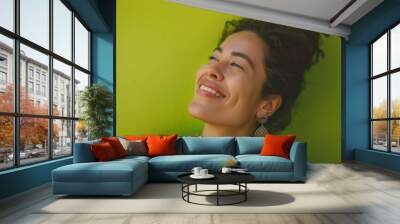 Joyful woman portrait on lime green background, a natural portrait of a woman expressing joyful Wall mural