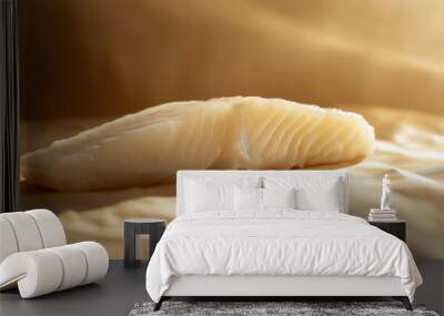 a fillet of halibut with a light, flaky texture and a hint of lemon against an isolated warm-toned background Wall mural