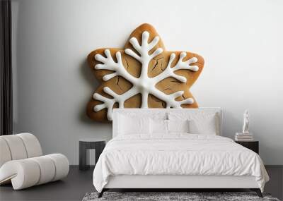 a gingerbread cookie with icing decoration in the shape of a snowflake against an isolated white background Wall mural